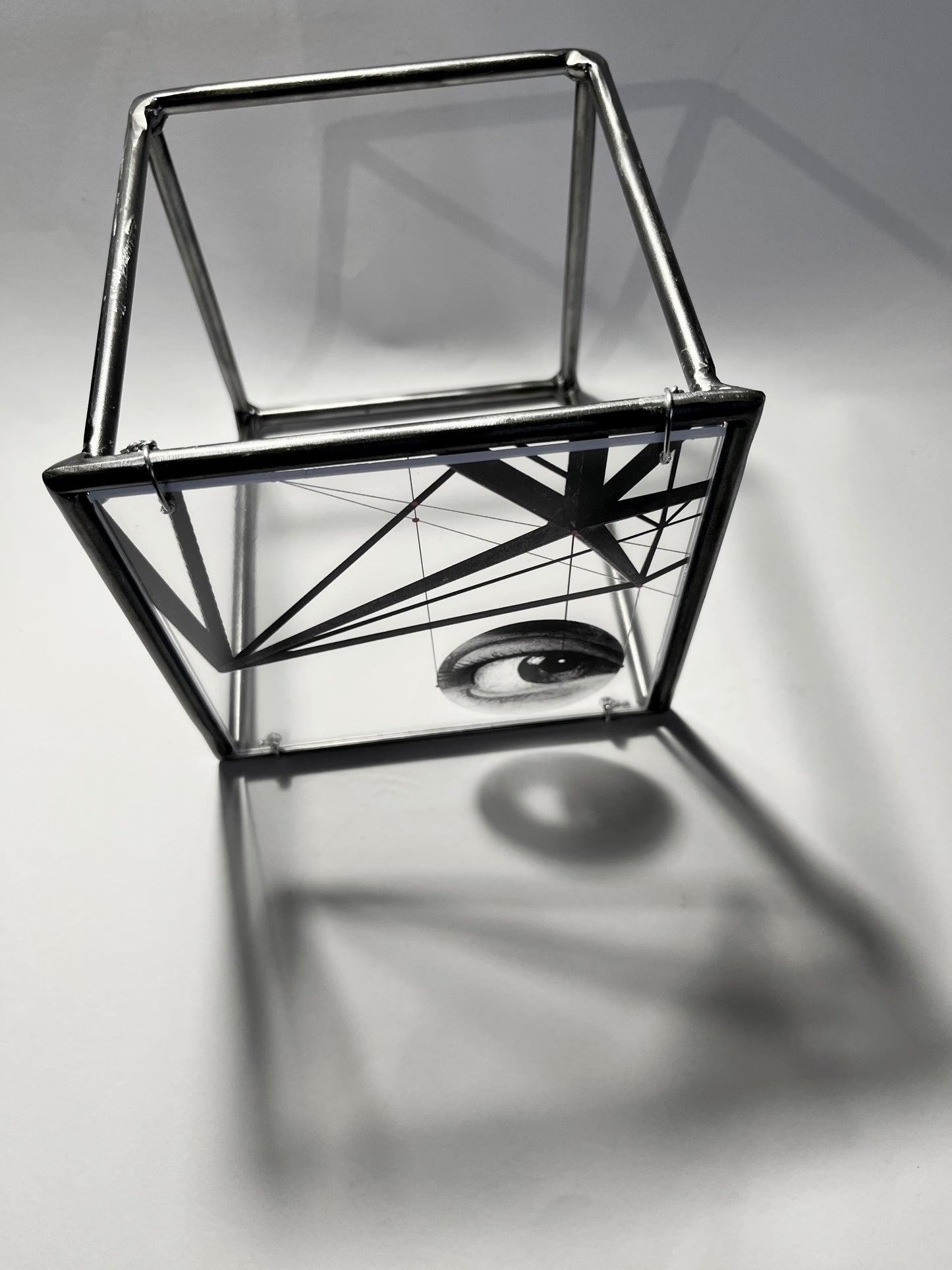 # overview in infinity curve of shadow from steel sculpture with surrealist eye image on acrylic glass. Modern Interior Metal Wall Art Sculpture Knowing Glance – Original Shadow Sculpture by Furst_Ori | ArtandShadow Artandshadow