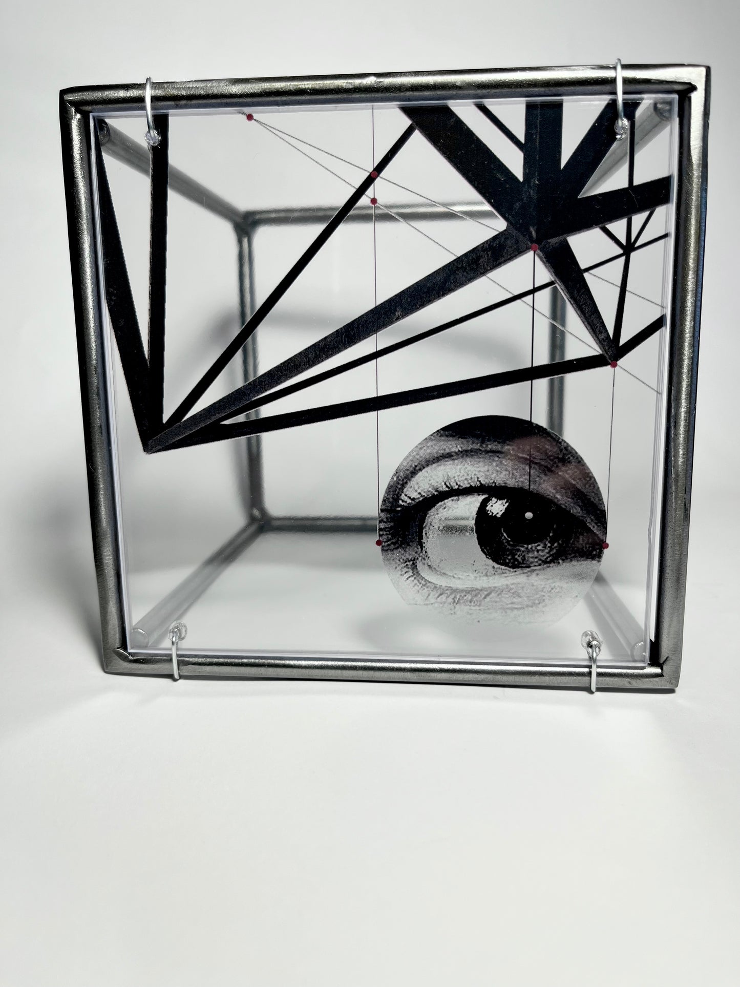 # surrealist eye and metal structure collage printed on acetate, housed in a steel bar frame. Modern Interior. Metal Wall Art Sculpture Knowing Glance – Original Shadow Sculpture by Furst_Ori | ArtandShadow Artandshadow