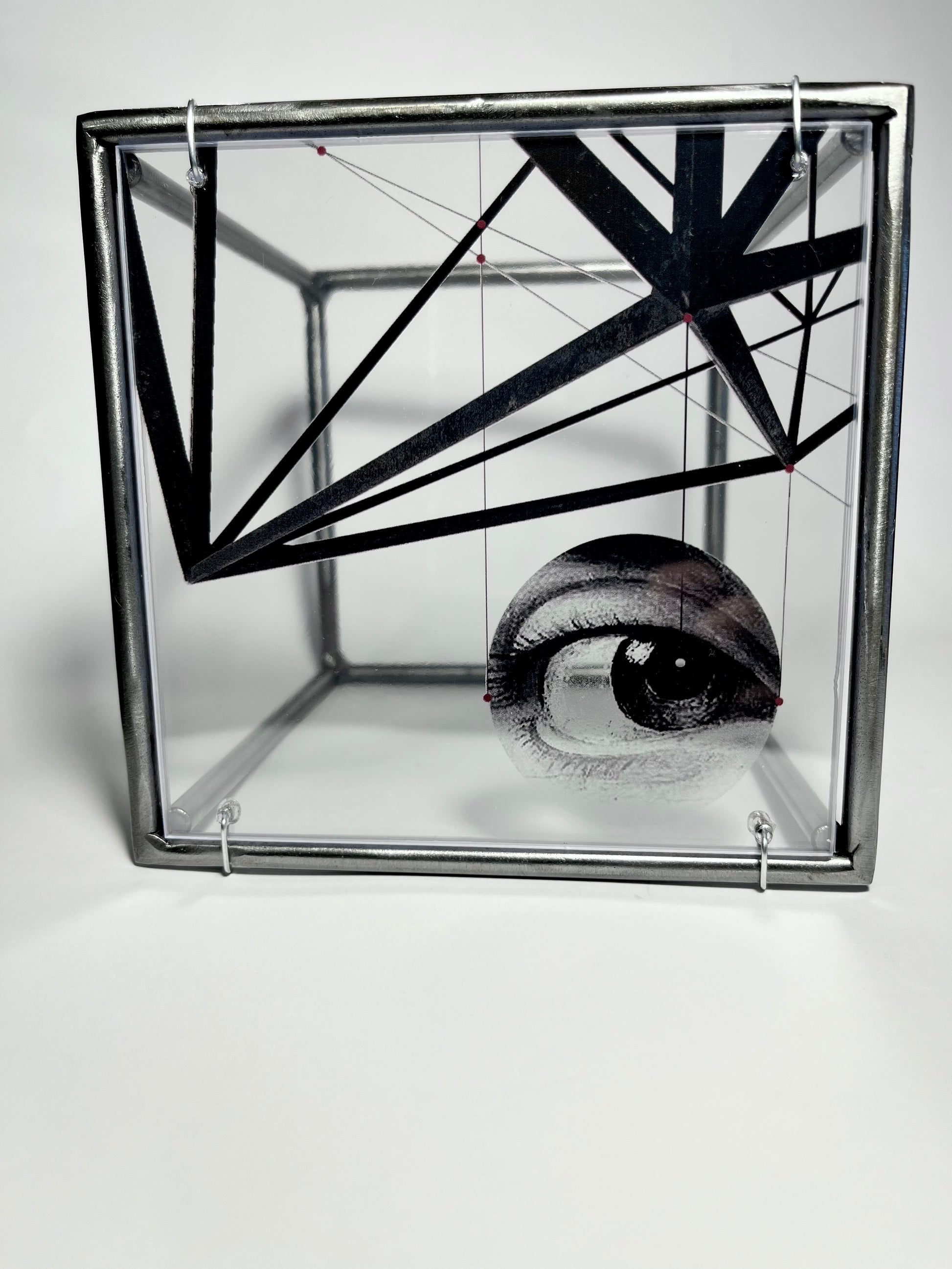 # surrealist eye and metal structure collage printed on acetate, housed in a steel bar frame. Modern Interior. Metal Wall Art Sculpture Knowing Glance – Original Shadow Sculpture by Furst_Ori | ArtandShadow Artandshadow