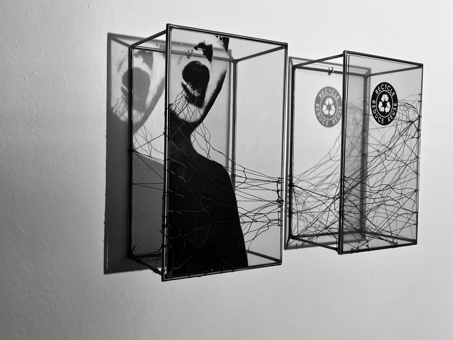 # Front view of of two-set shadow sculptures with strong shadow. Woman with open mouth and handwoven thread emerging. Numbered Limited Edition Wall Sculpture Play on Words: Limited Edition Light & Shadow Sculpture Artandshadow