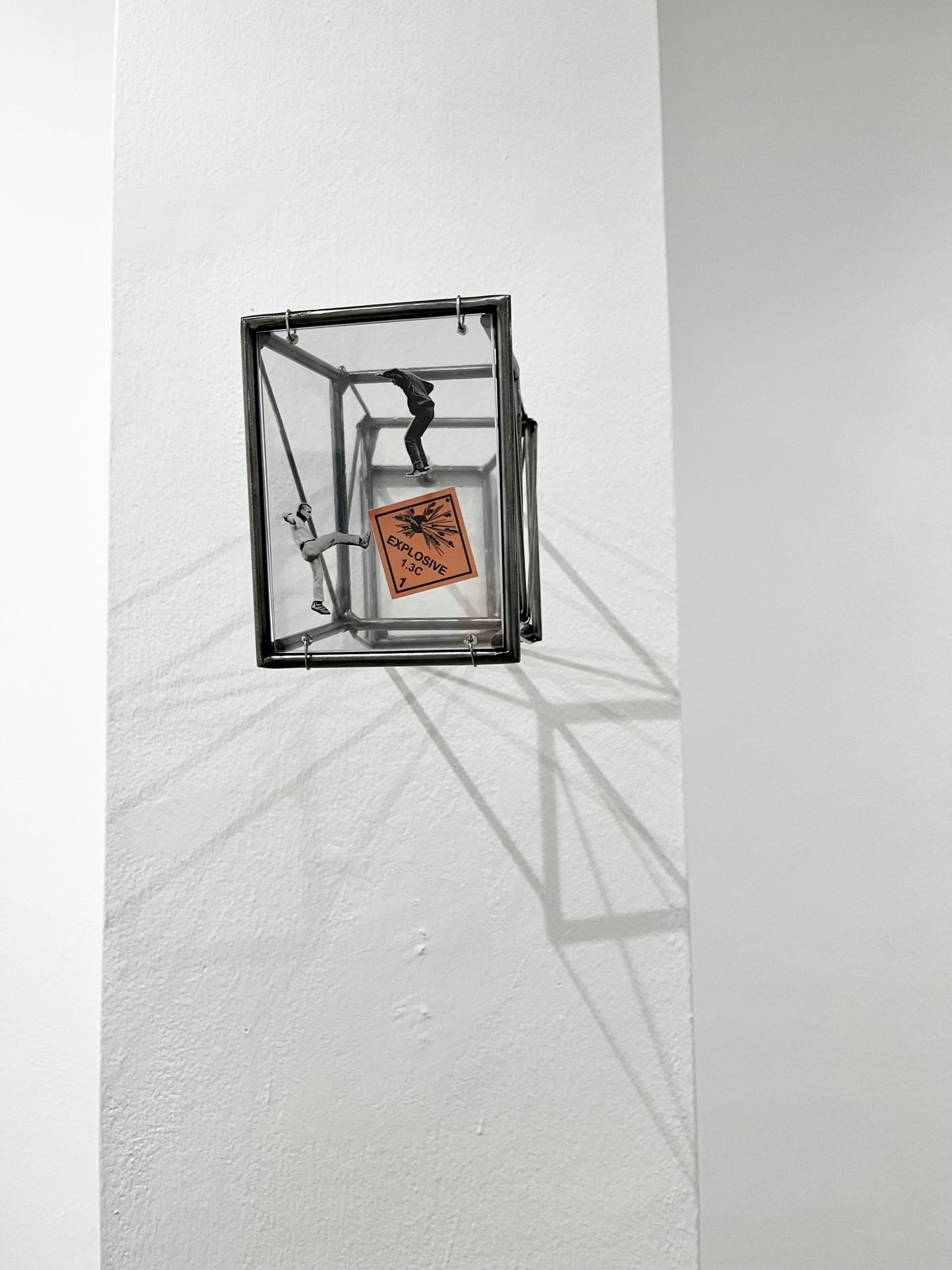 # multiple light sources giving shadow effect on white walls form steel structure tunnel projecting from gallery wall. Numbered Limited Edition Wall Sculpture Social Explosion Sign: Limited Edition Light and Shadow Sculpture Artandshadow