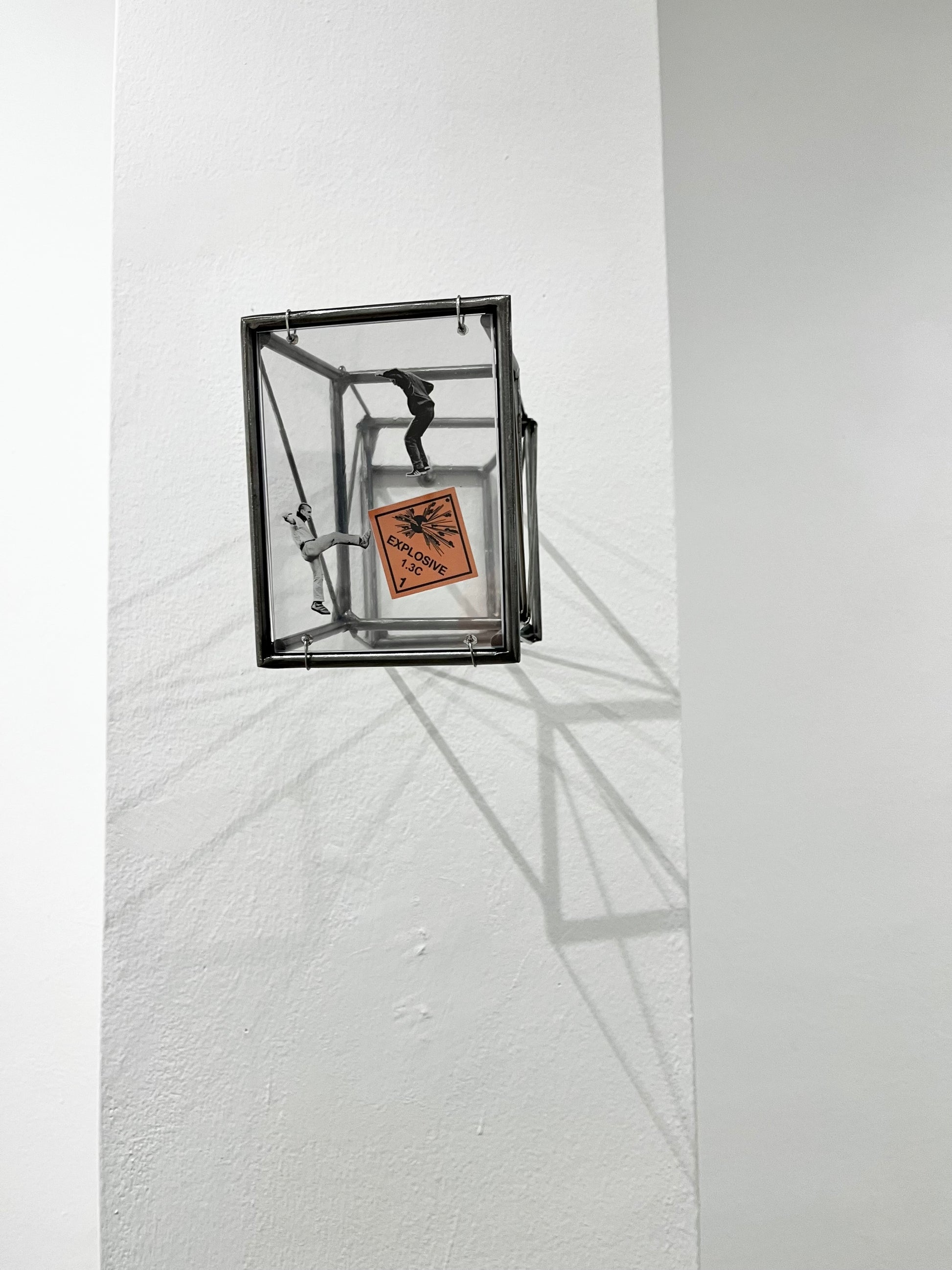 # multiple light sources giving shadow effect on white walls form steel structure tunnel projecting from gallery wall. Numbered Limited Edition Wall Sculpture Social Explosion Sign: Limited Edition Light and Shadow Sculpture Artandshadow