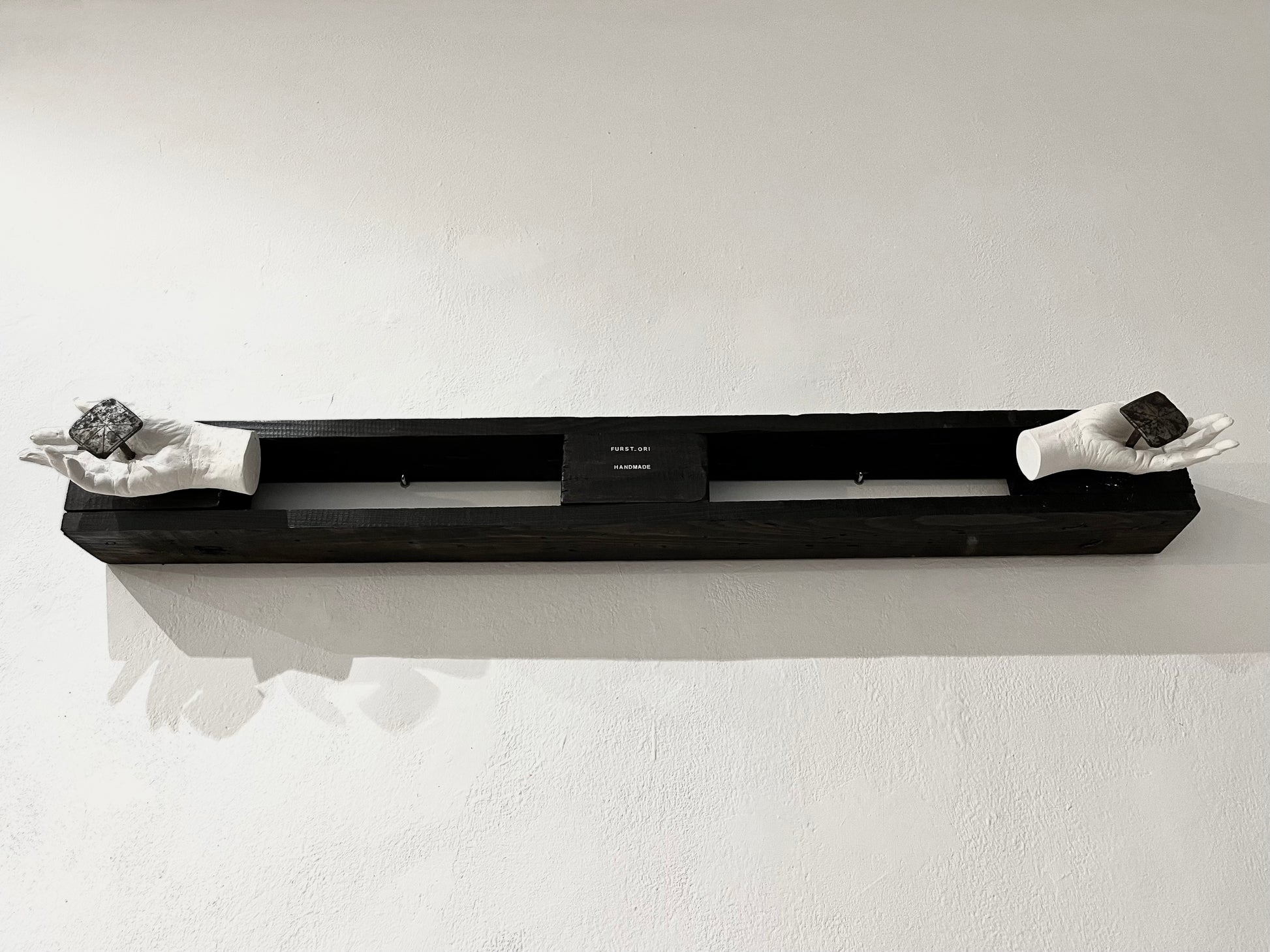 The artists hands caste in plaster and crucified onto wood by two antique decorative forged nails. 