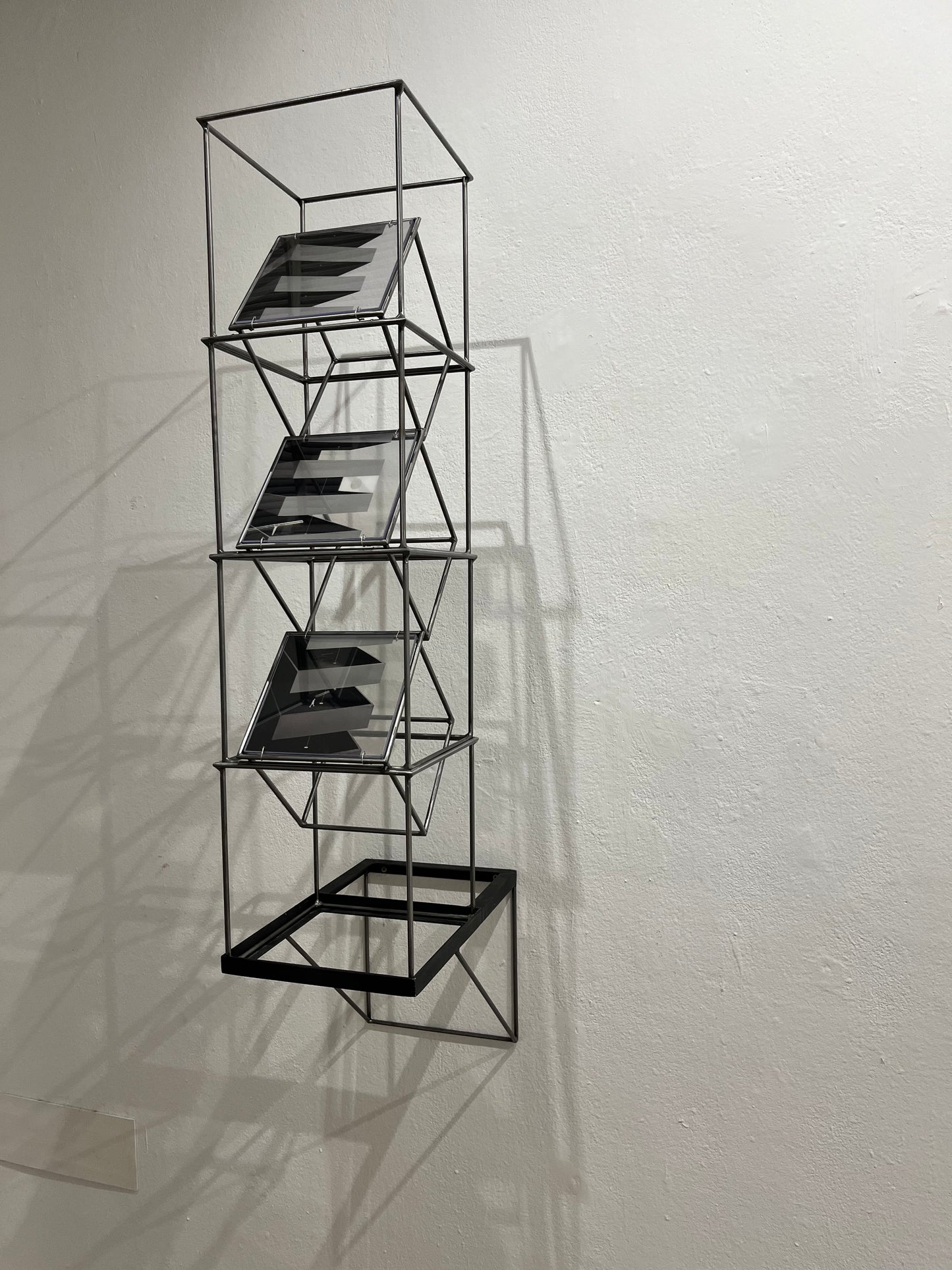 # Multiple light sources causing shadow painting on wall from steel metal sculpture with architectural image printed on acetate. Numbered Limited Edition Wall Sculpture Brutalist Tower – Limited Edition Shadow Sculpture by Furst_Ori Artandshadow