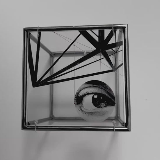 # close up of eye and steel steel structure surrealist shadwo sculpture