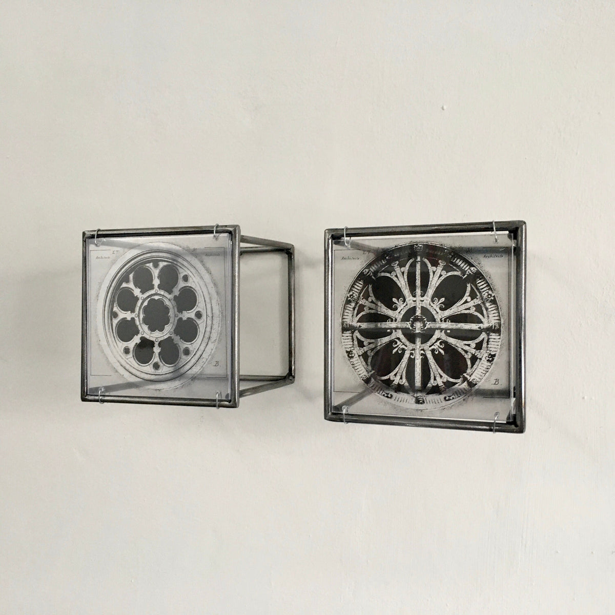 # side view of vintage architectural drawings of two French rose windows —  Château de Chantilly and Église Saint-Léonard de Croissy-sur-Seine, printed on transparent acetate housed in steel frame. Modern Interior Metal Wall Art Sculpture Rose Window Diptych - Architectural wall art Artandshadow