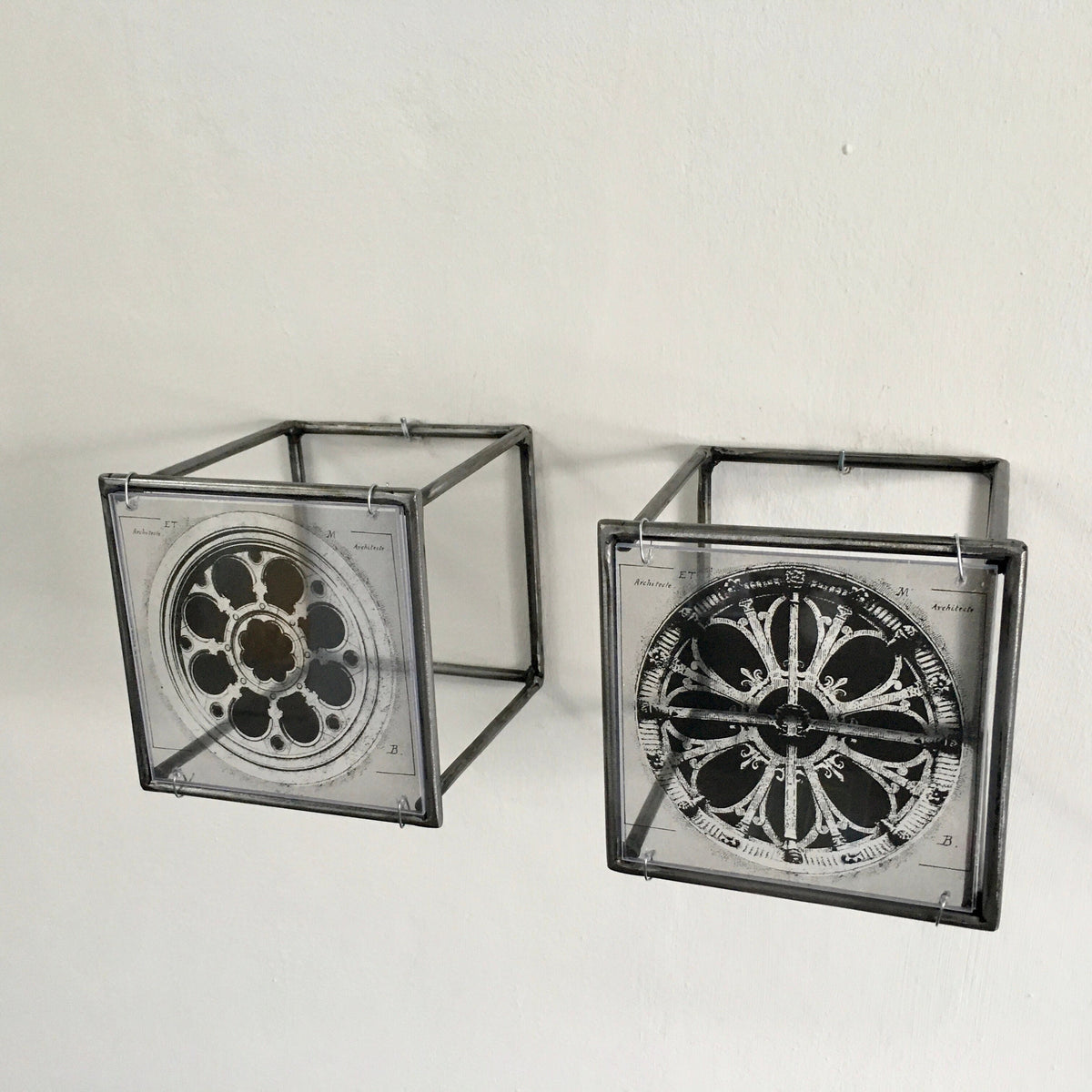 # vintage architectural drawings of two French rose windows —  Château de Chantilly and Église Saint-Léonard de Croissy-sur-Seine, printed on transparent acetate housed in steel frame projecting from wall. Modern Interior Metal Wall Art Sculpture Rose Window Diptych - Architectural wall art Artandshadow