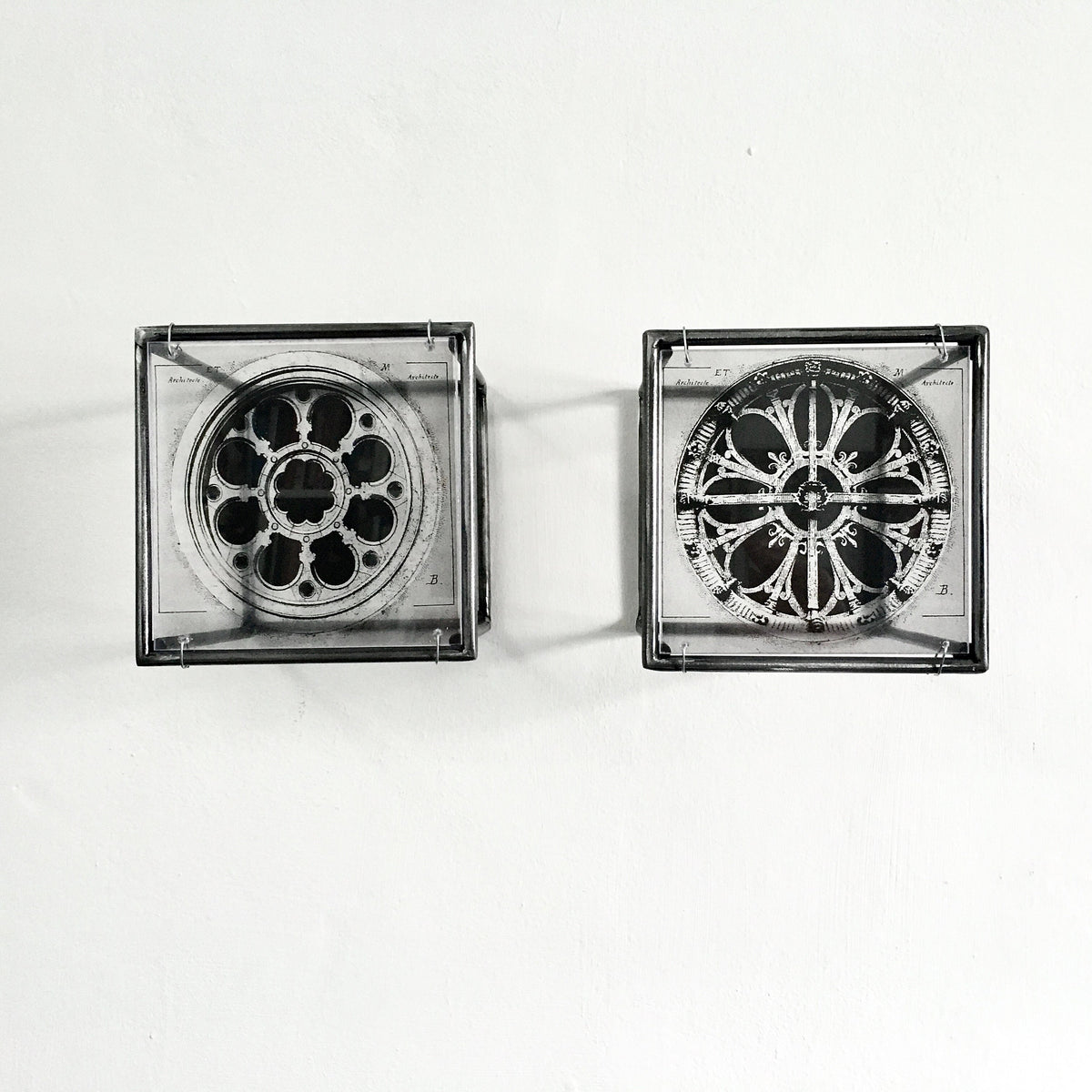 # vintage architectural drawings of two French rose windows —  Château de Chantilly and Église Saint-Léonard de Croissy-sur-Seine, printed on transparent acetate housed in steel frame. Modern Interior Metal Wall Art Sculpture Rose Window Diptych - Architectural wall art Artandshadow